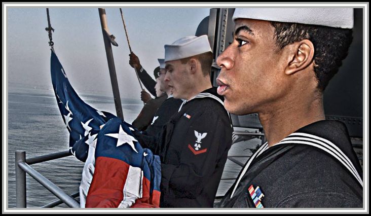 scan of image - Sailors prepare to raise the American Flag during morning colors.