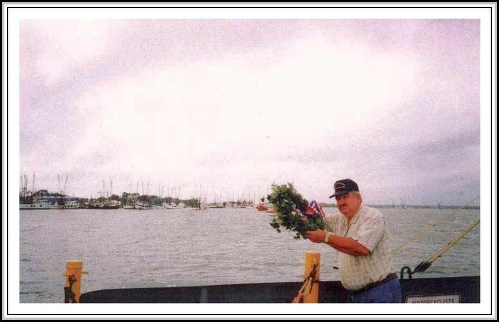 photograph of Ray Crumley performing the Memorial Service off the May Port Ferry 